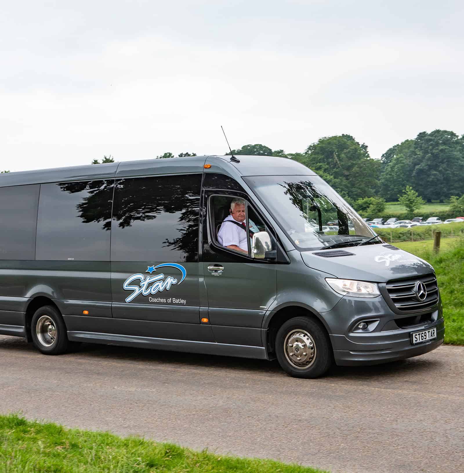 A Star Coaches minibus with a professional driver, highlighting comfort and options for every Minibus Hire Leeds Size.
