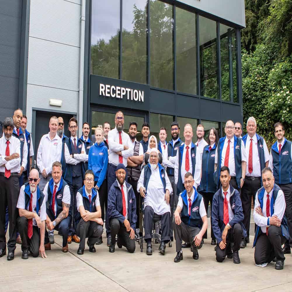 Star Coaches professional team portraying our minibus hire leeds services in front of reception.