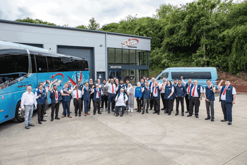a Driver with 16 Seater Minibus Hire 3 Group photo of people outside Star Coaches building with minibus hire.